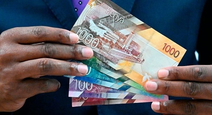 financialcrime-1 Central Bank of Kenya (CBK) Governor Patrick Njoroge displays some of the new look shilling Kenyan currency notes on June 3, 2019 during a press conference at his office in Nairobi. - The unveiling of the new Kenyan bank notes has been greeted by some with disapproval, with Kenyans taking exception to the use of an image of a statue of the founding father Mzee Jomo Kenyatta printed on the notes. According to the 2010 Constitution of Kenya, notes and coins shall not bear the portrait of any individual. (Photo by SIMON MAINA / AFP) (Photo credit should read SIMON MAINA/AFP/Getty Images)